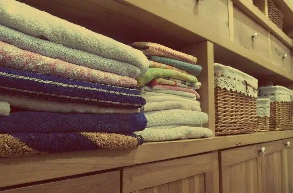 Labeled linen closet shelves sorted by category