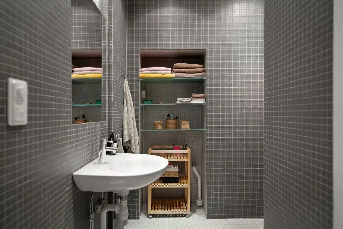 Small apartment bathroom with minimalist functional shelving